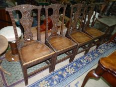 A set of four carved early Oak Dining Chairs having solid seats,