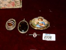 Four brooches including polished stone, glass and small portrait in various unmarked metal frames.