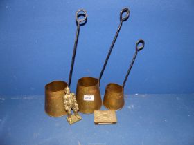 Three graduated brass measures and a brass matchbox holder.