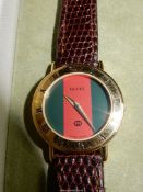 A Gucci 3000L Gold Plated quartz Ladies Wristwatch with leather strap in Gucci box.