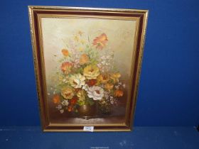 An Oil on canvas depicting a still life of flowers signed lower right Tranly, 14'' x 18''.