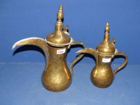 Two Brass Arab Dallah coffee pots, 14 3/4" and 11 3/4".
