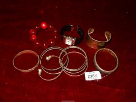 A quantity of silver and white metal bangles etc.