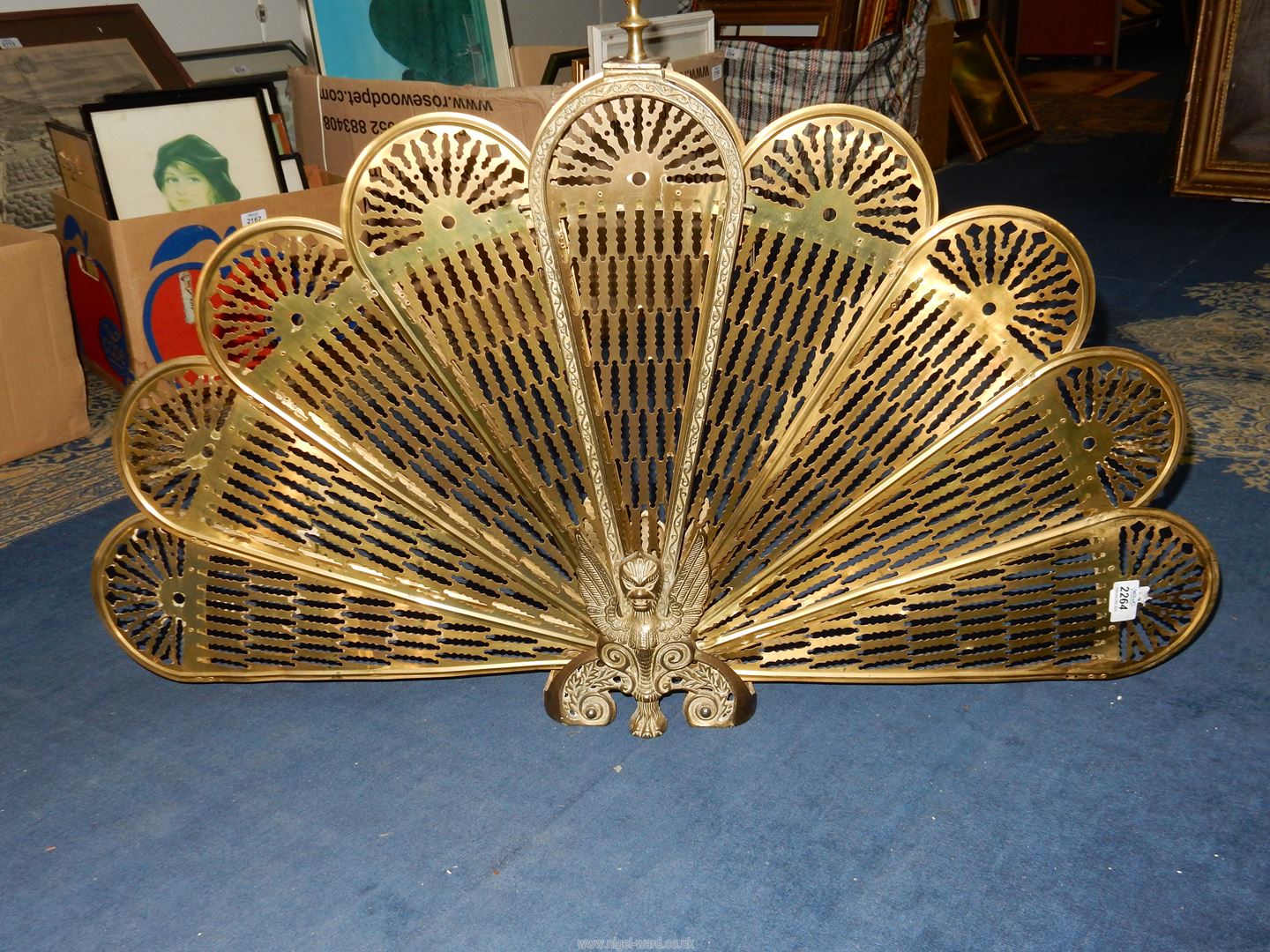 A Brass Peacock tail Fire screen, 23½" tall.