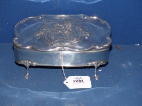 An ornate Silver jewellery Casket with scroll edges and embellished with a panel of a young girl on