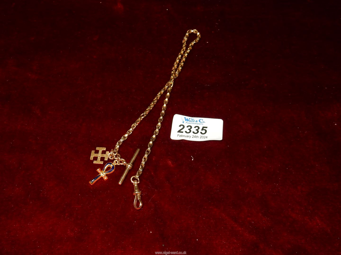 A 9ct gold watch chain with two charms attached, 14" long overall, 14.83 gms.