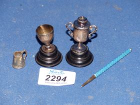 Two small miniature Silver trophies on wooden stands, Birmingham 1906, makers Robert Pringle & Son,