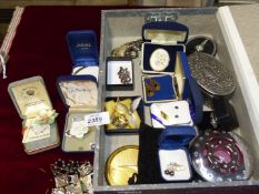 A box of brooches, a silver and amber pendant and earring set, Vogue compact, Swarovski trinket box,