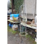 An obelisk and floor standing candle holder.