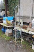 An obelisk and floor standing candle holder.