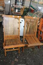 Pair of teak folding garden chairs.