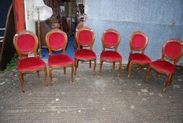 A set of six Mahogany/Walnut framed oval backed dining chairs standing on front cabriole legs and