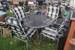 Glass topped Patio table, 40'' diameter x 28'' high, with four chairs and cushions.