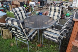 Glass topped Patio table, 40'' diameter x 28'' high, with four chairs and cushions.