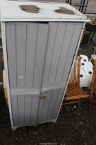 Plastic storage cupboard, planter and water butt with tap.