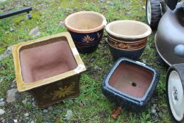 Four small glazed pots.