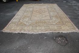 A pale cream bordered, patterned and fringed Rug with three guls, 167'' x 125''.