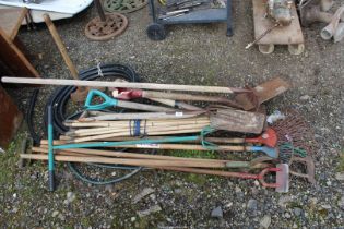 Large quantity of garden tools including forks, rakes, sledge hammer, etc.
