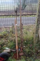 Grass hook, pick axe and hand cultivators.