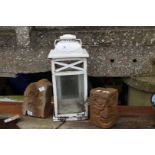 Outdoor lantern and two carved stone pillars.