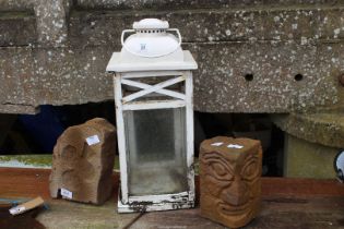 Outdoor lantern and two carved stone pillars.