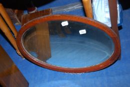 An oval bevel plated wall mirror.