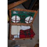 A Picnic hamper with contents and picnic blanket by Dongora.