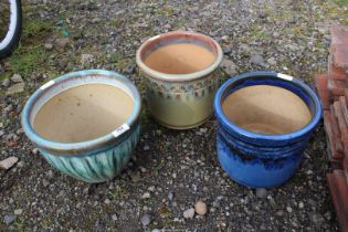 Three glazed pots.