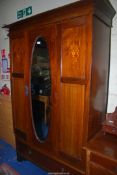 A Mahogany double Wardrobe with inlaid details to the panels, with lower drawer,