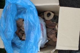 A box of archeological pottery finds.