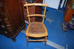 A cane seated bedroom chair.