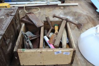 Box of miscellanea including wet stone, masonry hammer, pulleys, etc.