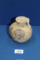 An ancient Corinthian aryballos, 6th century BC, for restoration; broken with an area of loss,