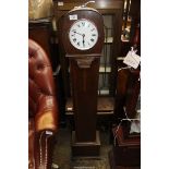 An Oak cased Grandmother Clock, the white face with Roman numerals having a later quartz movement,