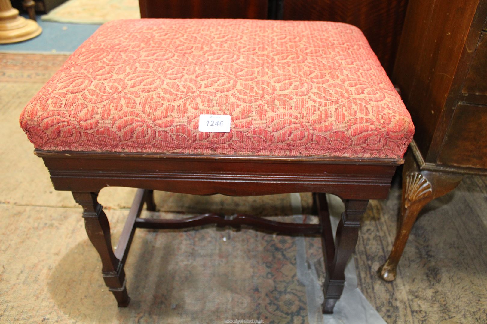 A Mahogany framed Piano Stool standing on shaped square legs,