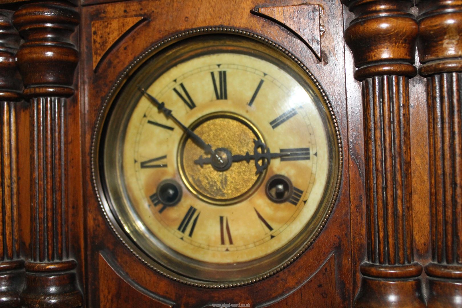 A Mantle clock with pine cone detail to the pediment and columns to either side of the clock face, - Image 3 of 3