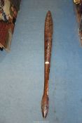An old Tribal Pacific dance paddle decorated with black and red triangles,