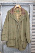 A Gents outdoor Tweed coat by Grenfell in olive green with red, black and mustard check,