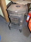 A cast iron woodburning Stove by Coalbrookdale, 27 1/2'' high x 15'' wide x 16'' deep max.