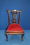 An elegant and charming miniature Chippendale style Mahogany side Chair having a carved and