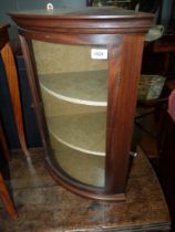 A Mahogany framed curved glass doored wall hanging display Cabinet with an olive green lined