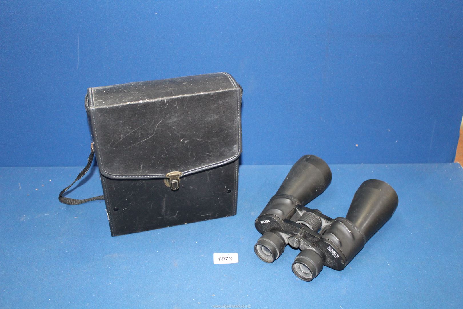 A cased pair of Sakura 60 x 90 Binoculars with grids visible, for naval or marine use.
