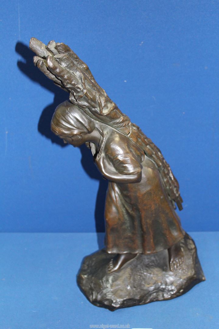 A heavy cast Bronze figure of a female peasant carrying firewood on her back, signed T. - Image 3 of 4