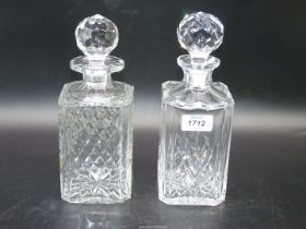 Two square crystal decanters with stoppers, 10 1/4" tall and 10" tall.