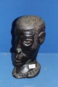 A large African tribal bust of a gentleman, 12 1/2'' tall, a/f.