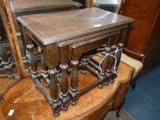 A nest of three rectangular Oak occasional Tables standing on turned legs,