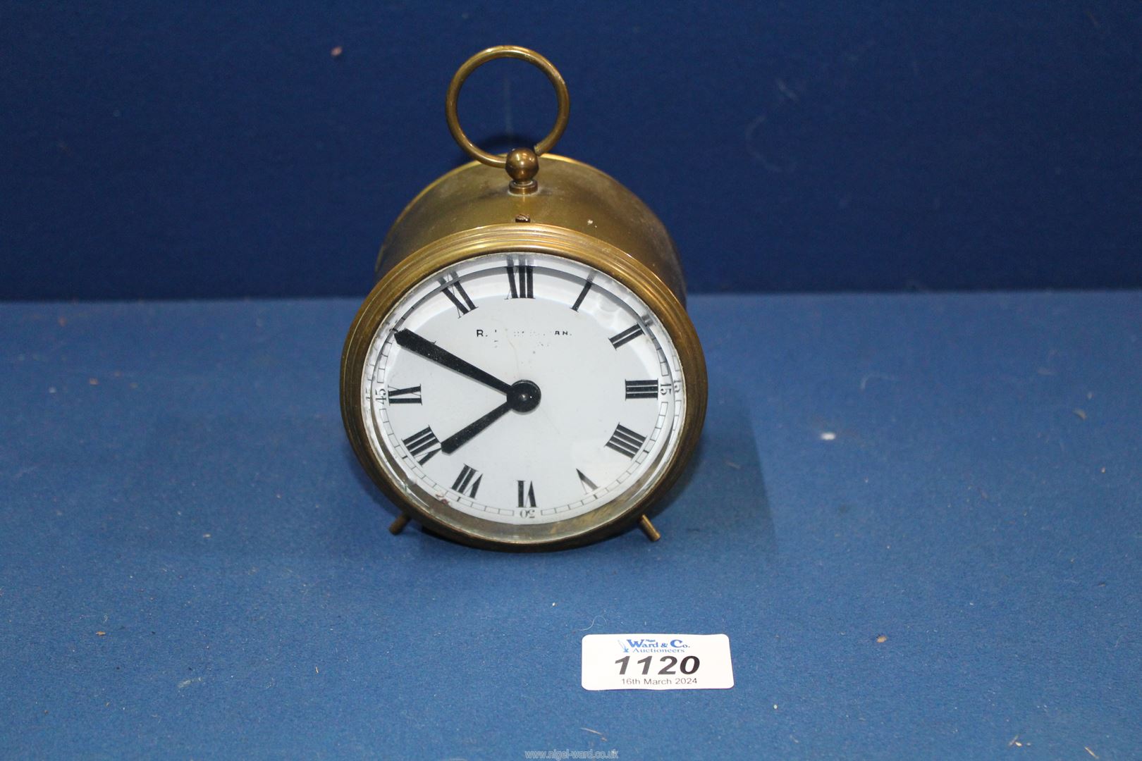 A circular brass drum Railway clock having white enamel face,