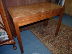 A Teakwood flapover Card Table standing on square legs and having a green baize top,