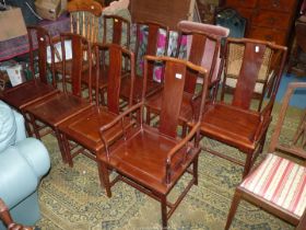 A set of eight Eastern/Chinoiserie hardwood dining chairs including two carvers standing on turned