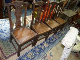 A set of four carved early Oak Dining Chairs having solid seats,